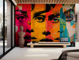 Bright pop art mural with expressive faces in neon pink, yellow, and teal