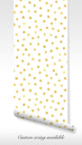 Modern polka dot wall covering featuring golden accents on a clean canvas