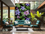 Nature-themed wallpaper featuring bold monstera leaves and vibrant purple blooms