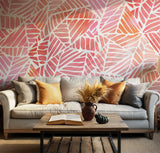 Modern palm leaf wallpaper in warm pink and orange tones for stylish living rooms